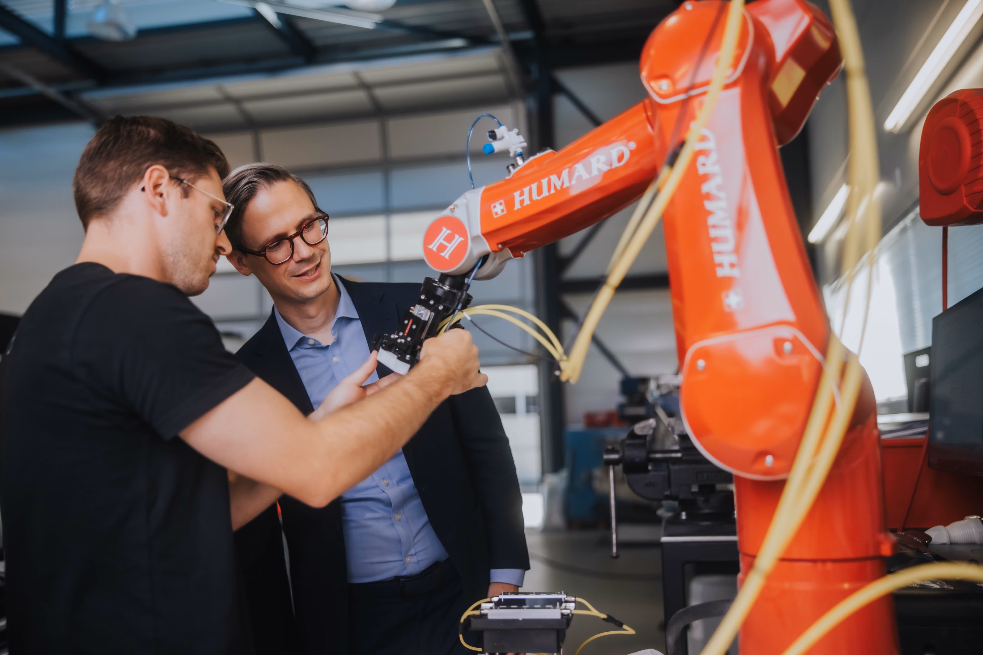 A specialist working with an industrial robot