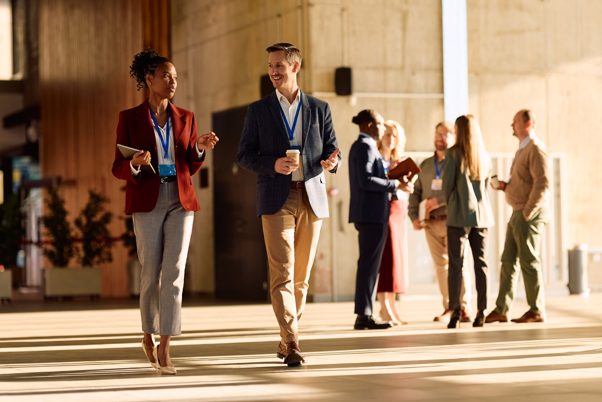 Colleagues walking and talking at a conference venue