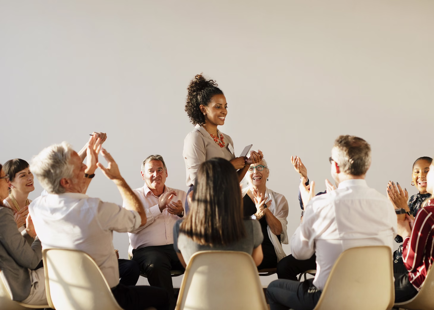 People applauding during a meeting