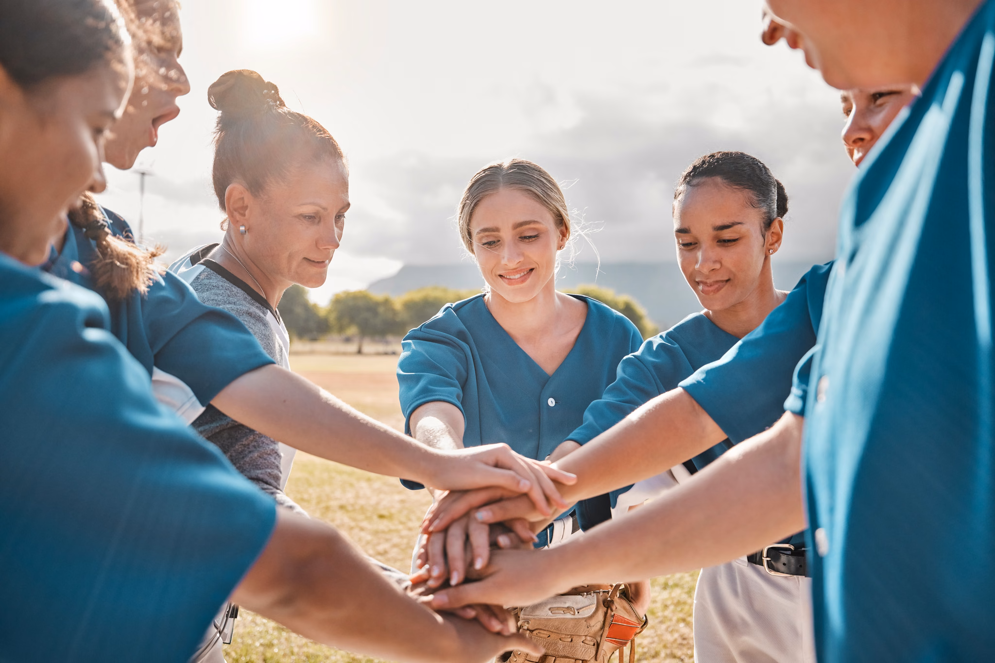 A team putting their hands in together outdoors